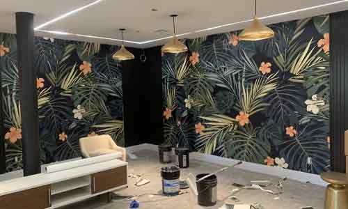 Professional wallpaper hanging on living room wall